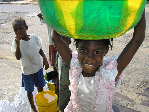 Children from Liberia carrying a pail